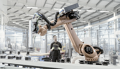 Engineer programming robots at a robotics research facility